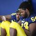 Michigan junior defensive tackle Quinton Washington and sophomore defensive tackle Richard Ash look at a cell phone during media day at the Al Glick Field House on Sunday afternoon. Melanie Maxwell I AnnArbor.com